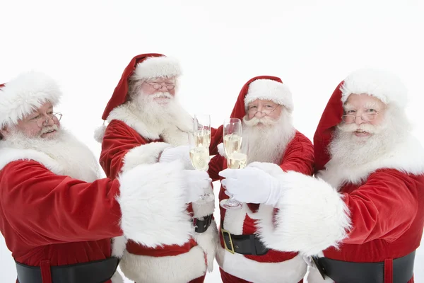 Skupina mužů v santa claus oblečení opékání flétny Champagne — Stock fotografie