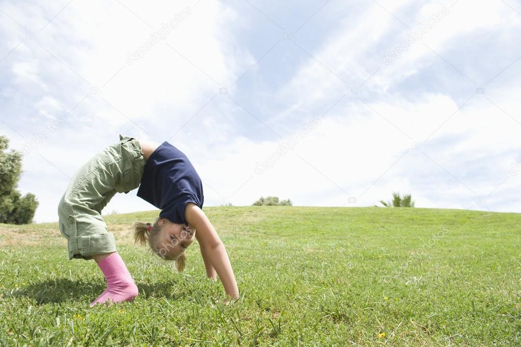 Girl Bending Over Backwards On Grass