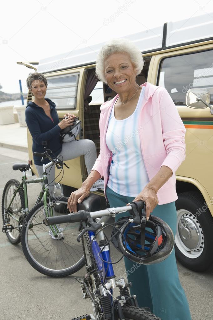 Senior Women Standing With Mountain Bikes