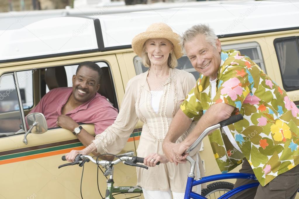Couple With Bicycle And Friend In RV