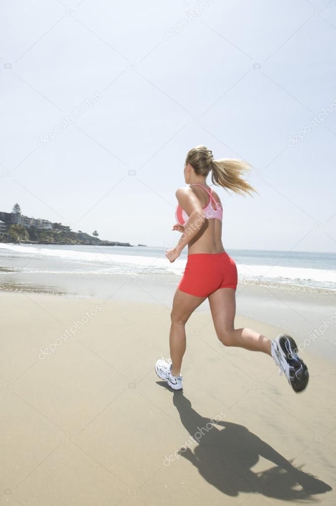 Woman Jogging At Beach