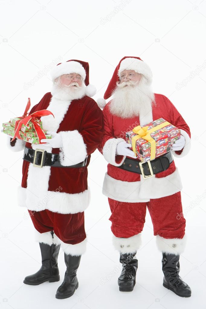 Men In Santa Claus Outfits Holding Gift Boxes