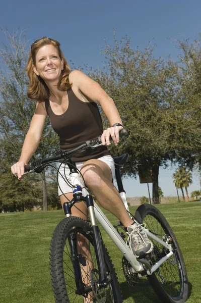 Mulher com bicicleta no parque — Fotografia de Stock