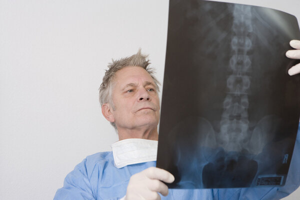 Doctor Analyzing X-Ray Report
