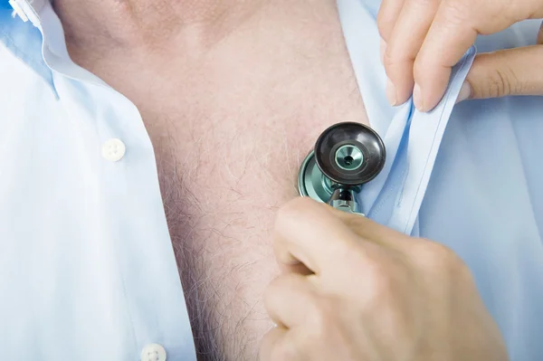 Closeup Of A Male Doctor's Hand Checking Patient's Heartbeat — Stock Photo, Image