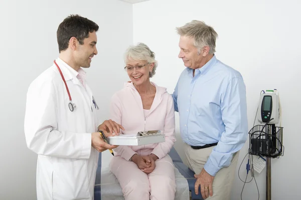Doctor Showing Reports To Senior Couple — Stock Photo, Image