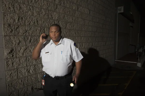 Security Guard With Walkie Talkie And Torch Patrols At Night — Stock Photo, Image