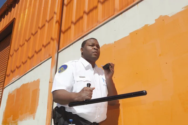 Security Guard With Baton Using Walkie Talkie — Stock Photo, Image