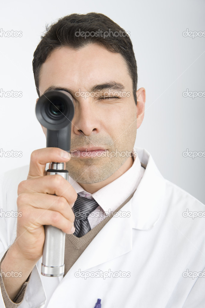 Doctor Looking Through Ophthalmoscope