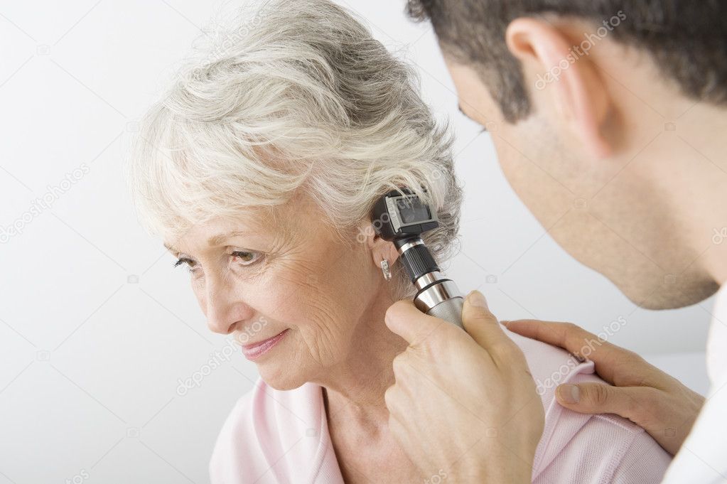 Doctor Examining Patient's Ear Using Otoscope