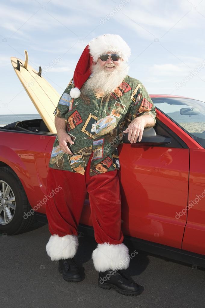 Father Christmas By Convertible With Surfboard