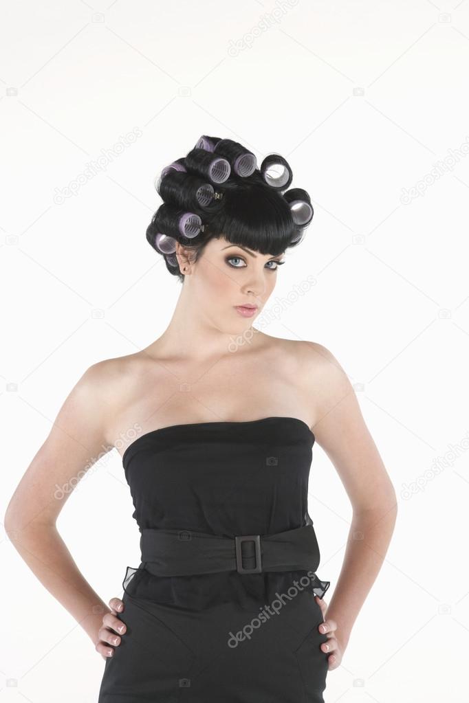 Young Model In Hair Rollers Standing With Hands On Hips