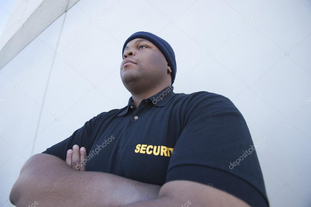 Young Security Guard By Wall