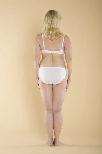 Back view of a semi nude woman in white lingerie — Stock Photo, Image