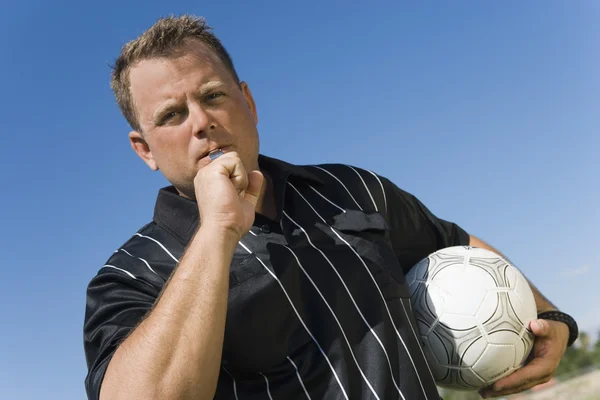 Low angle view of soccer referee showing yellow card against blue sky — Stock Photo, Image