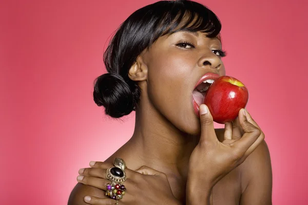 African american woman bite apple Stock Photo