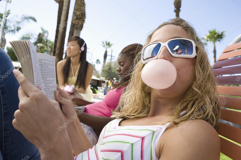 female blowing bubble gum