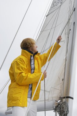 Man Holding Rigging On Sailboat clipart