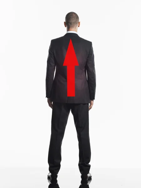 Uomo d'affari con freccia rossa sul retro — Foto Stock