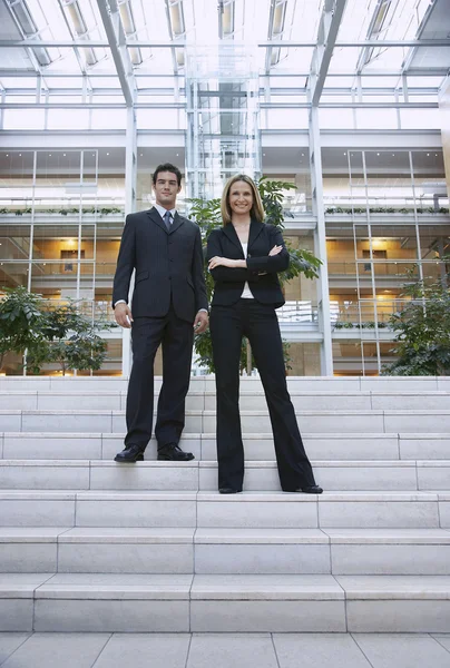 Businesspeople Standing On Office Stairs — Stock Photo, Image