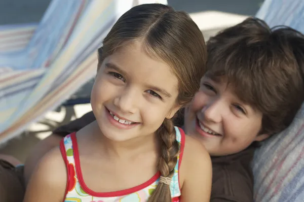 Happy Siblings Relaxing On Deckchair — Stock Photo, Image