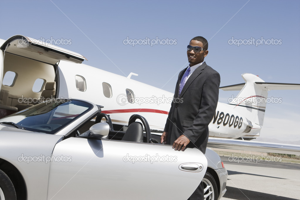 Businessman Standing By Car At Airfield