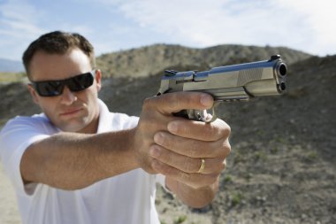 Man Aiming Hand Gun