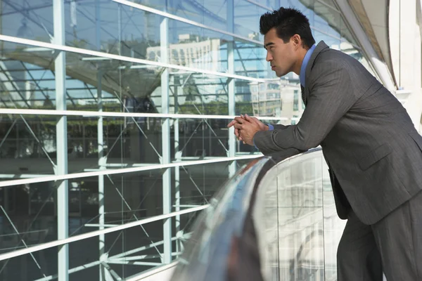 Thoughtful Businessman Leaning On Railing — Stock Photo, Image