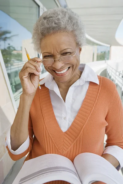 Female professor adjusting glasses — Stock Photo, Image