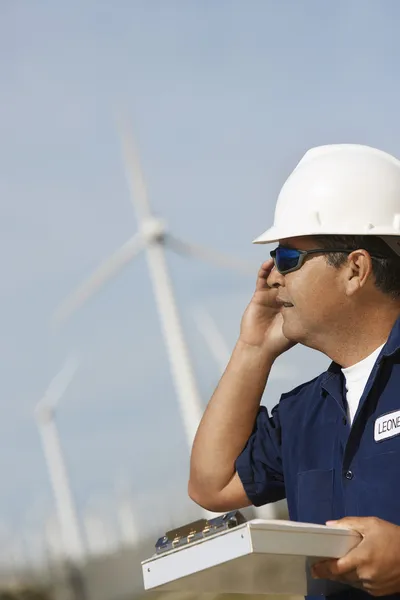 Engineer Using Mobile Phone At Wind Farm — Stock Photo, Image