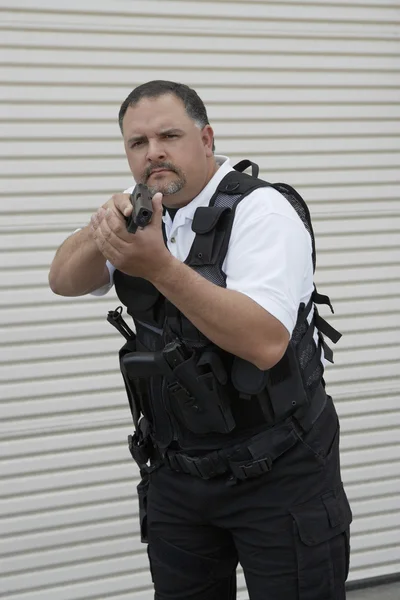 Security Guard In Bulletproof Vest Holding Gun — Stock Photo, Image