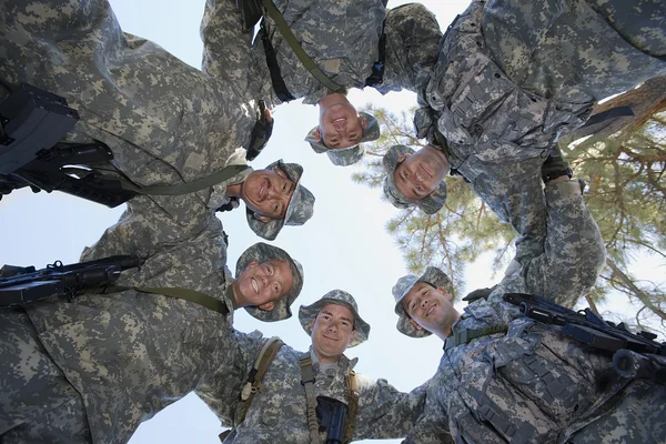 Lage hoek portret van soldaten huddling — Stockfoto