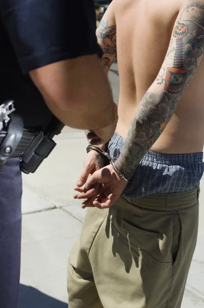 Oficial de policía arrestando a un joven — Foto de Stock