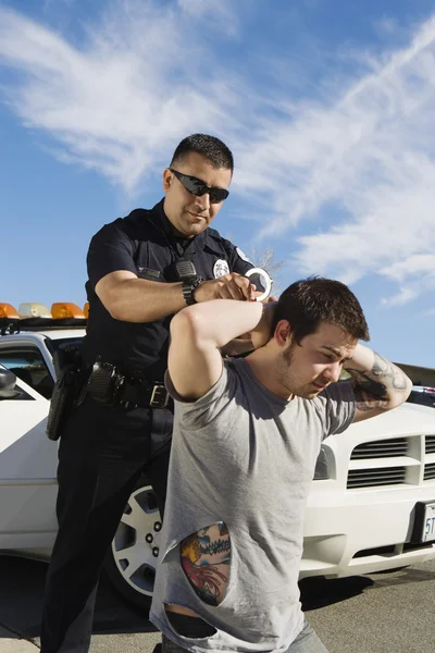 Police Officer Arresting Young Man — Stock Photo, Image