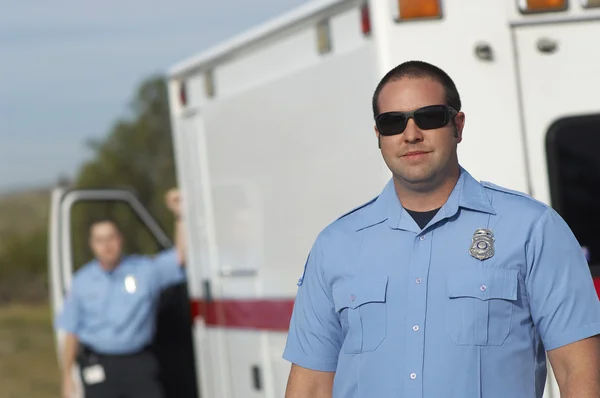 Paramedic In Front Of Ambulance Royalty Free Stock Images