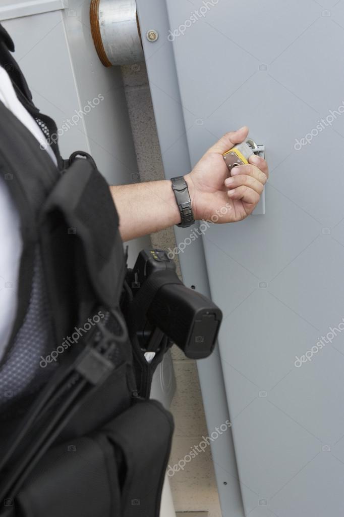 Security Guard Checking Padlock — Stock Photo © londondeposit 21957345