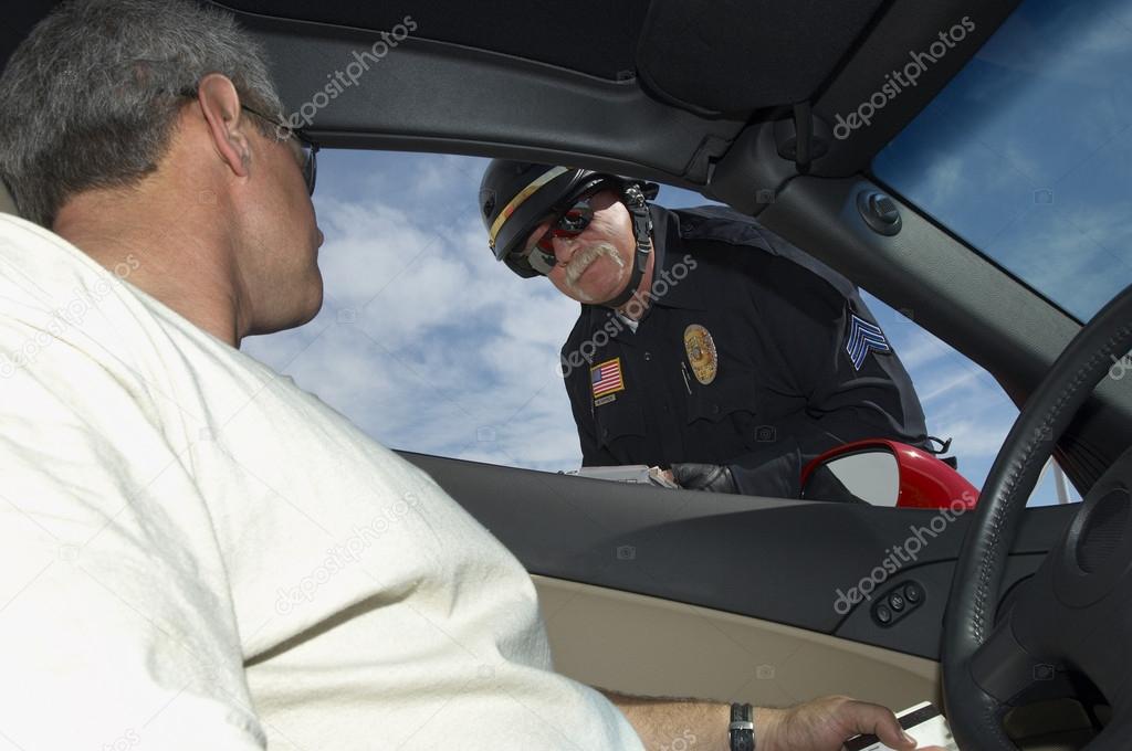 Man In Discussion With Police Officer