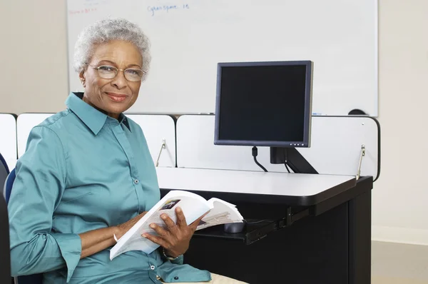 Happy Senior Teacher Holding Book — Stock Photo, Image