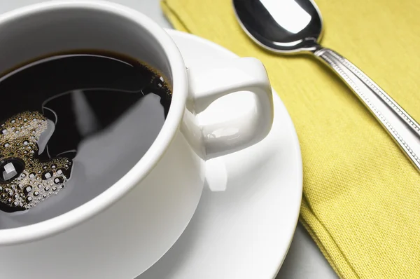 Tazza di caffè con tovagliolo e cucchiaio — Foto Stock