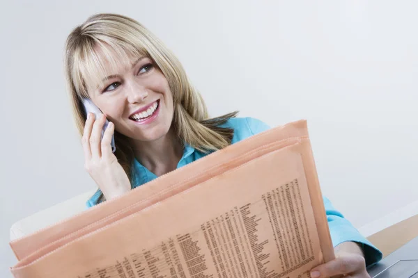 Woman With Finance Newspaper On Call — Stock Photo, Image