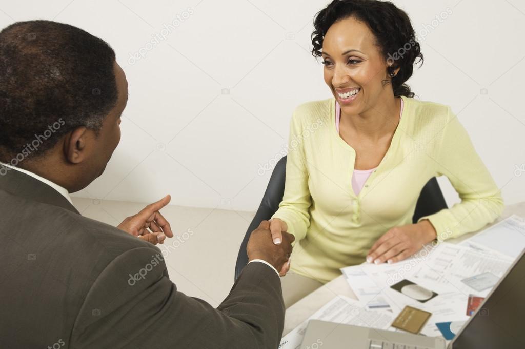 Woman Shaking Hands With Financial Advisor