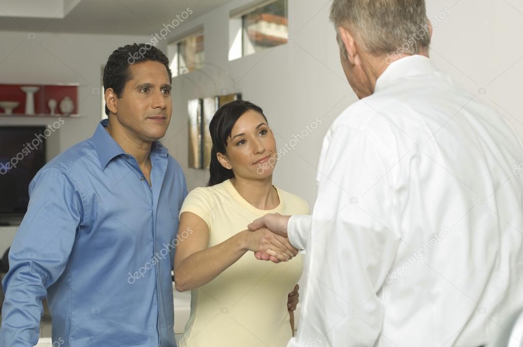 Couple Sealing A Deal With Financial Advisor