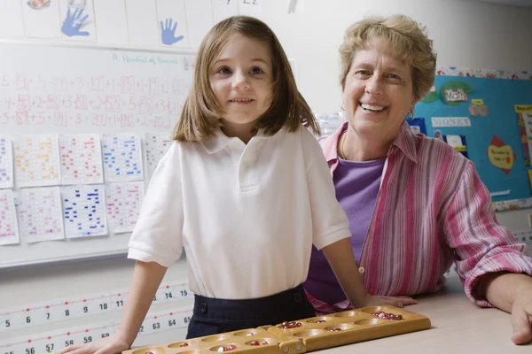 Teacher And Schoolgirl With Counting Tray — Stock Photo, Image