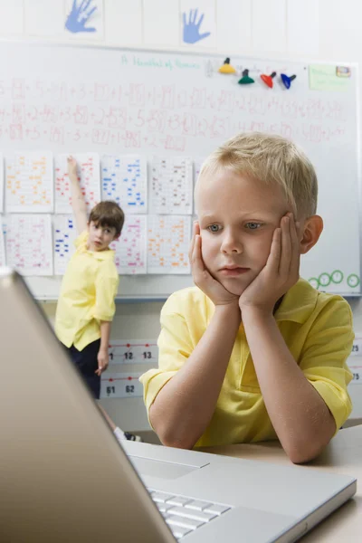 Skolpojke använder en bärbar dator — Stockfoto