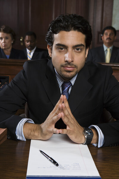 Confident Male Advocate Sitting In Courtroom