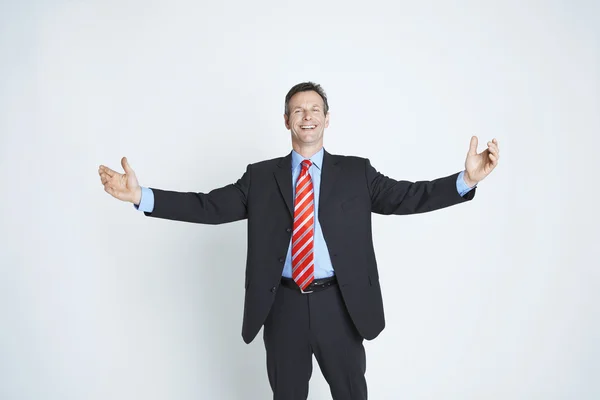 Studio Portrait Of Businessman With Arms Outstretched — Stock Photo, Image