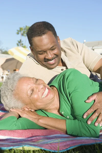 Mature Couple Relaxing In Lawn — Stock Photo, Image