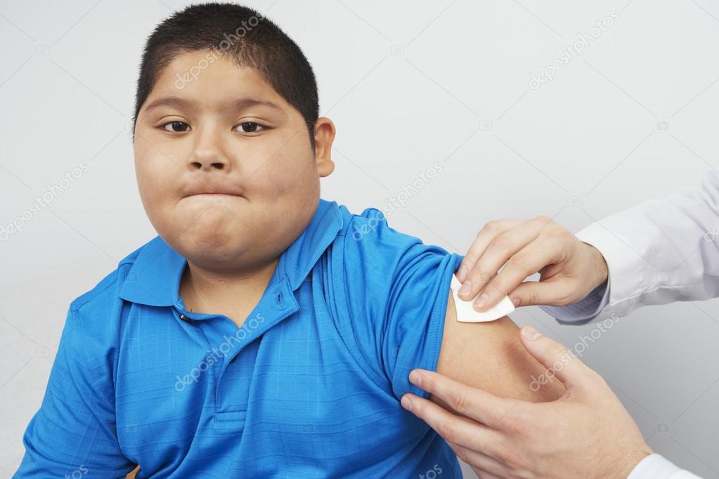 Disinfecting boy's arm