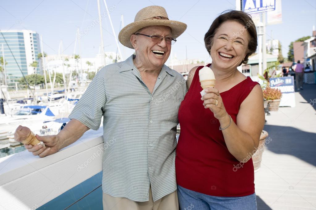 Cheerful Senior Caucasian Couple Holding Ice-creams