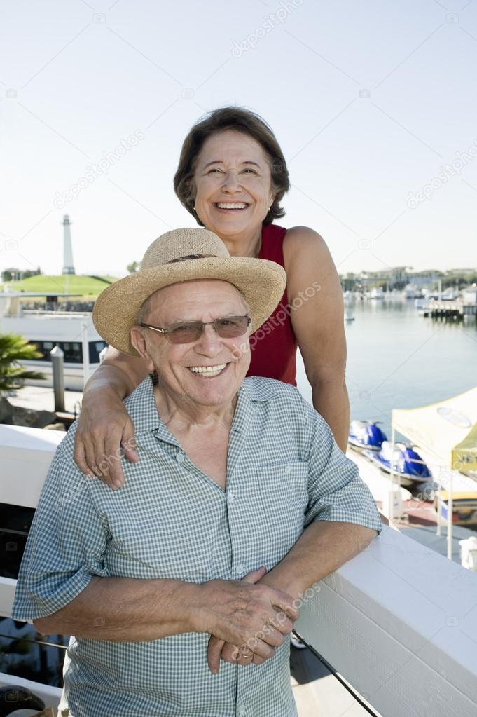 Portrait Of A Happy Senior Couple At Harbor